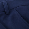 Close-up of navy blue trousers showing the waistband, belt loop, and front seam detail.