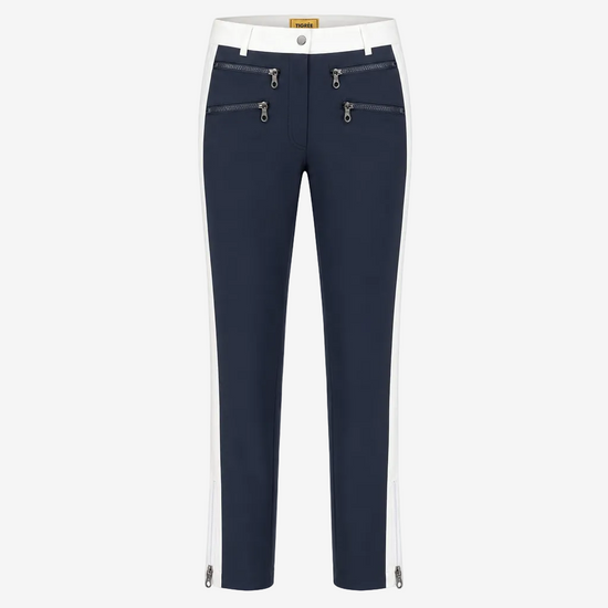 A pair of navy blue cropped pants with white side panels, featuring silver zipper details on the front and along the lower hems, shown against a plain white background.