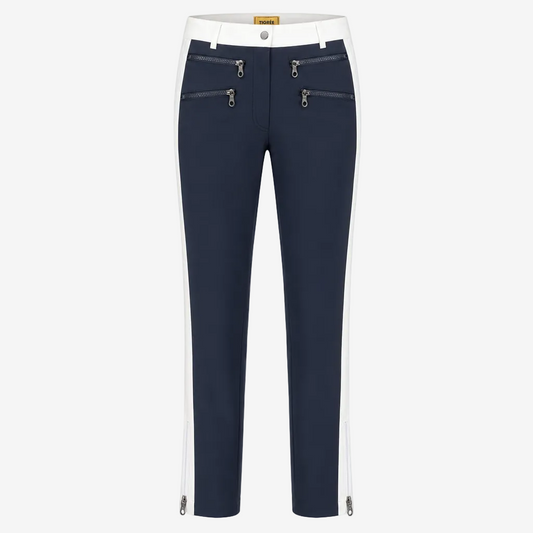 A pair of navy blue cropped pants with white side panels, featuring silver zipper details on the front and along the lower hems, shown against a plain white background.