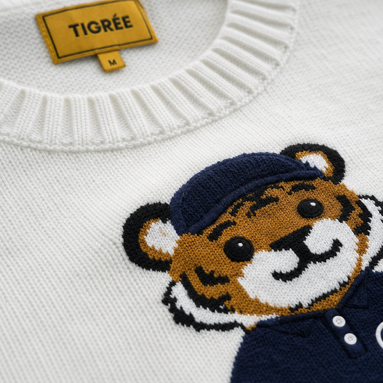 White sweater with a tiger emblem and 'Tigree' label