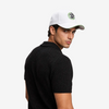 Man wearing a white cap with a logo on a light gray background