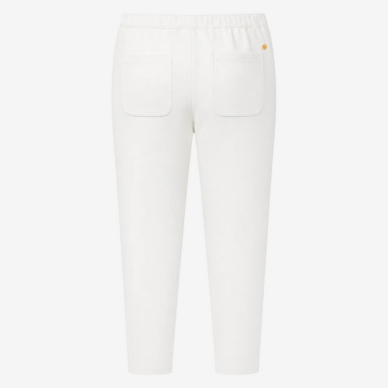 White cropped pants with an elastic waistband, two back patch pockets, and a small gold logo on the upper right hip, shown against a plain white background.