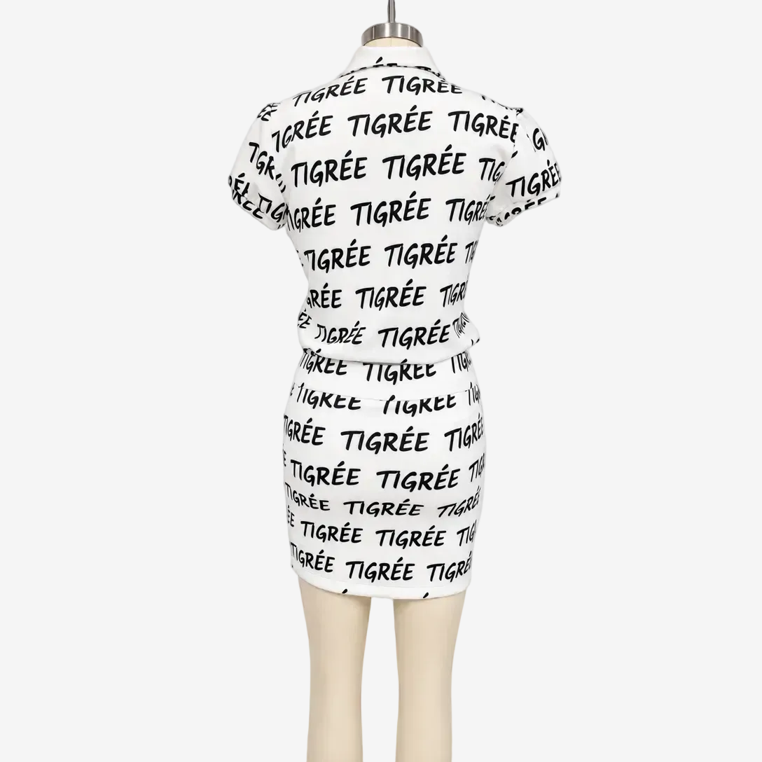 White dress with black text on a mannequin against a white background