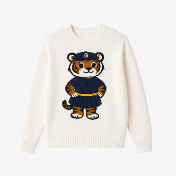 An off-white knit crewneck sweater featuring a central cartoon tiger graphic wearing a navy blue uniform with a yellow belt and a cap with a white monogram logo.