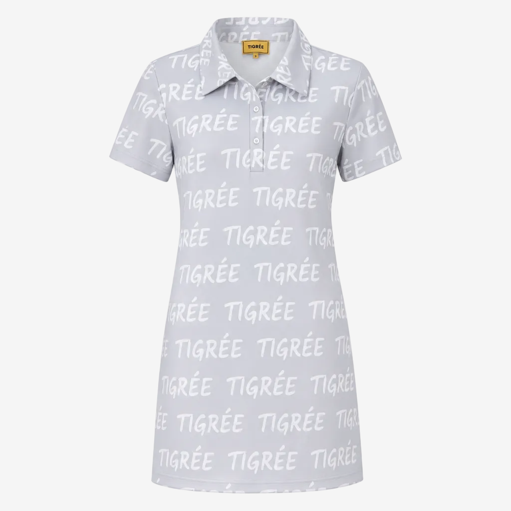 A short-sleeve polo shirt in white with an all-over light gray 'TIGRÉE' text pattern, featuring a classic collar and a three-button placket. A yellow 'THREE' brand label is visible inside the collar.
