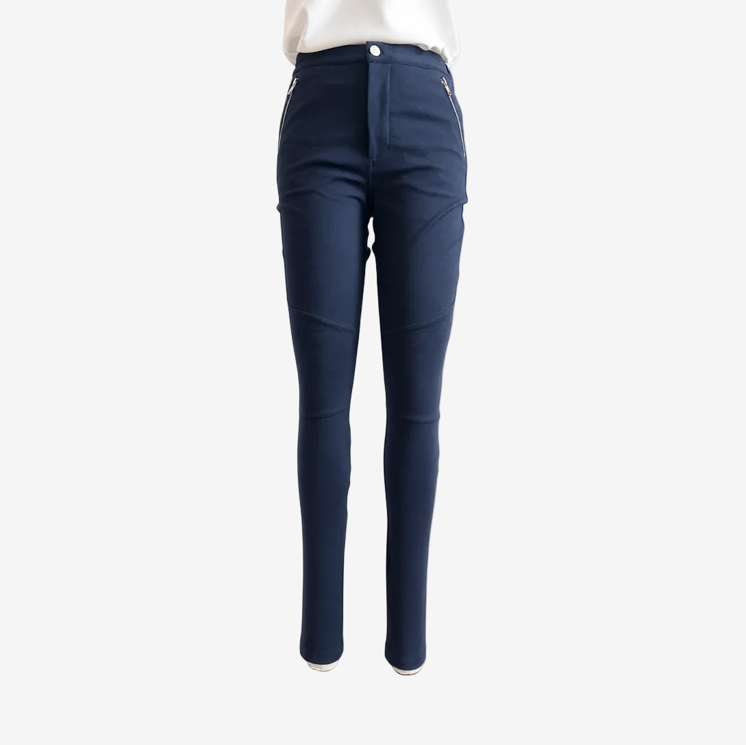 A pair of navy blue slim-fit pants shown on a model from the back, paired with a white top against a plain white background.