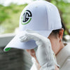 Person wearing a white cap with a logo and a golf glove, outdoors.
