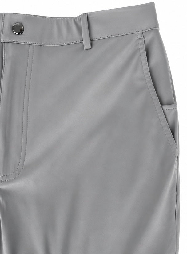 Close-up of light gray trousers showing the waistband with a button closure, belt loops, front seam, and side pocket.