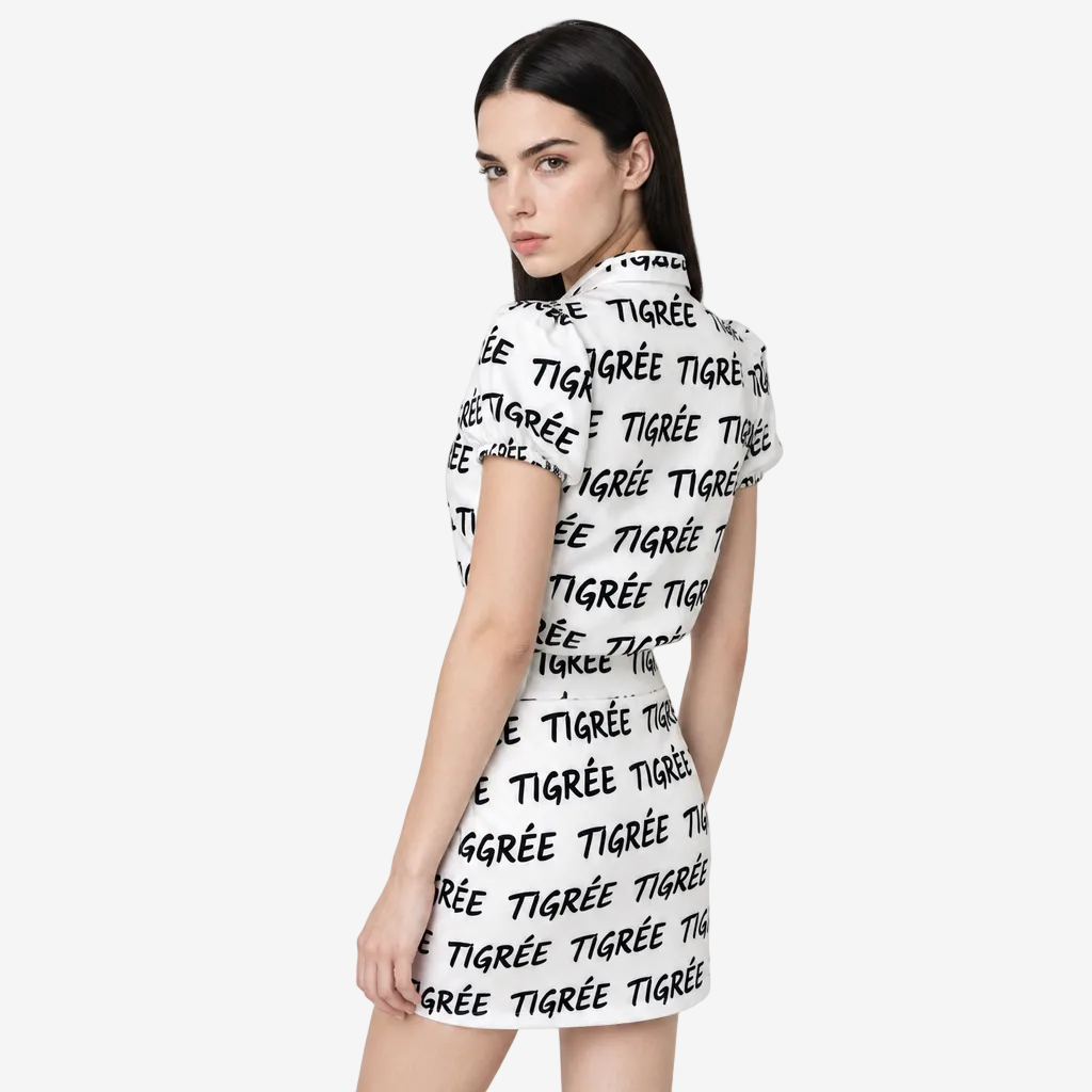 Woman wearing a white dress with black text on a plain background