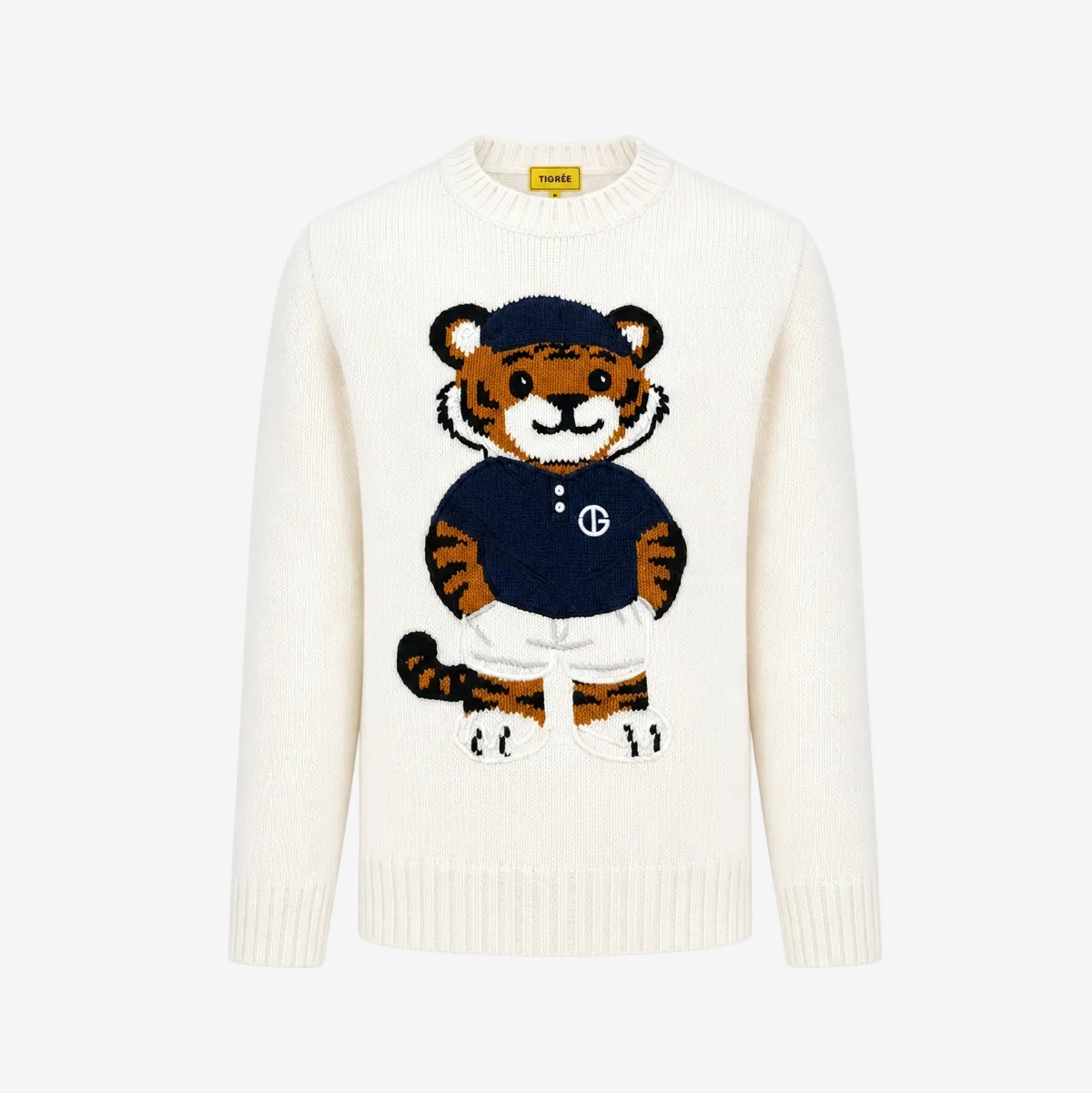 An off-white knit crewneck sweater featuring a large embroidered cartoon tiger mascot wearing a navy blue shirt and white trousers on the front. The brand label on the inner collar reads 'SWEAT'.