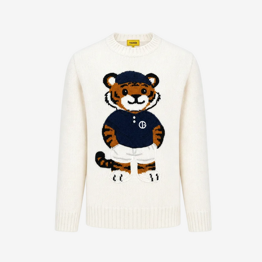 An off-white knit crewneck sweater featuring a large embroidered cartoon tiger mascot wearing a navy blue shirt and white trousers on the front. The brand label on the inner collar reads 'SWEAT'.