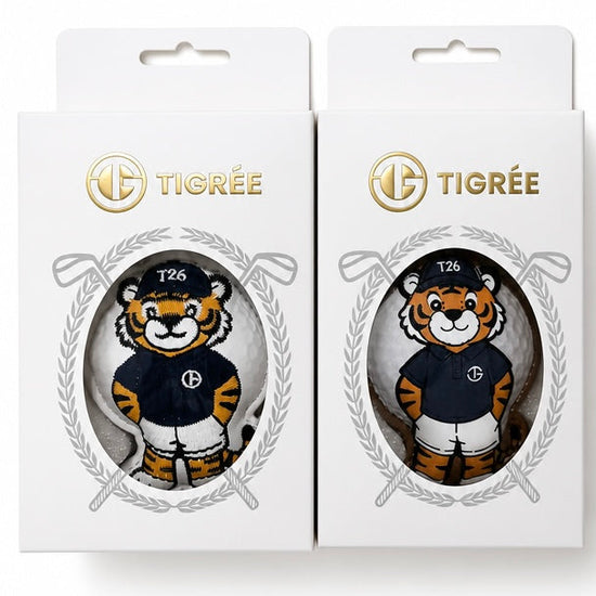 Two white Tigrée branded retail boxes, each featuring a die-cut window with a cartoon tiger mascot wearing a navy and white sports jersey. The boxes are shown side by side on a plain white background.