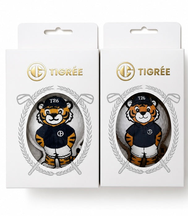 Two white Tigrée branded retail boxes, each featuring a die-cut window with a cartoon tiger mascot wearing a navy and white sports jersey. The boxes are shown side by side on a plain white background.